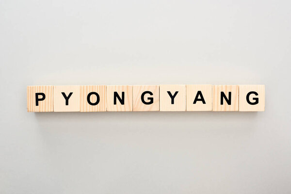 top view of wooden blocks with Pyongyang lettering on white background