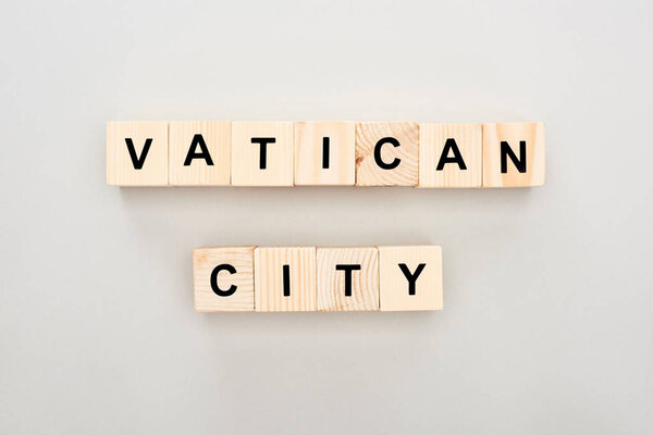top view of wooden blocks with Vatican City lettering on white background