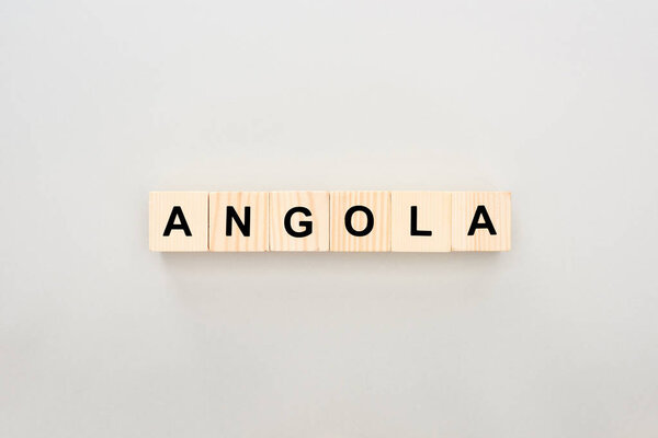 top view of wooden blocks with Angola lettering on white background