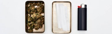 flat lay with metal box with marijuana buds and rolling paper near lighter, panoramic shot