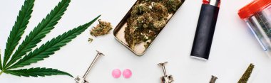 top view of marijuana buds, cannabis leaf, pills and syringes on white background, panoramic shot clipart