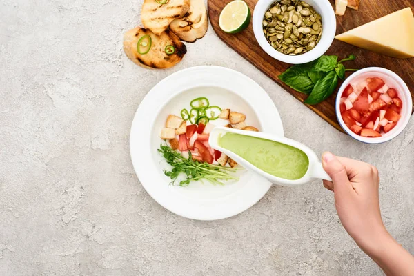 Cropped view of woman cooking green creamy soup near wooden cutting board with fresh ingredients — Stock Image Cropped View Woman Cooking Green Creamy Soup Wooden Cutting Board Stock Picture