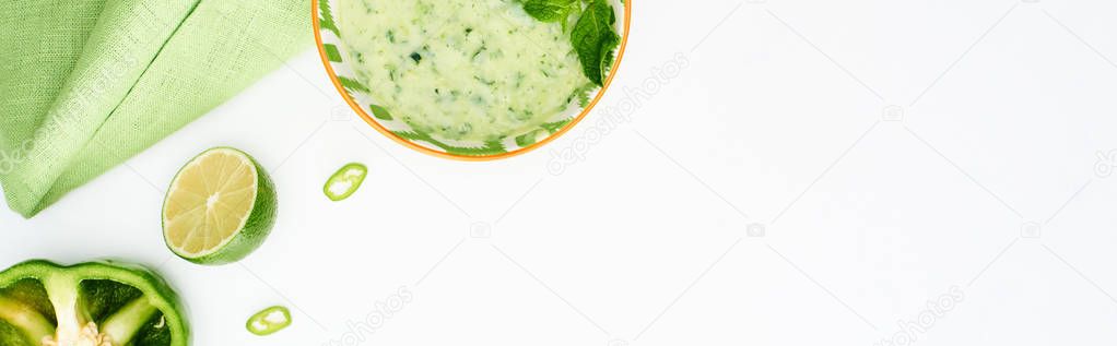 Top view of delicious creamy green vegetable soup served isolated on white with ingredients, panoramic shot — Stock Image Top View Delicious Creamy Green Vegetable Soup Served Isolated White Stock Picture
