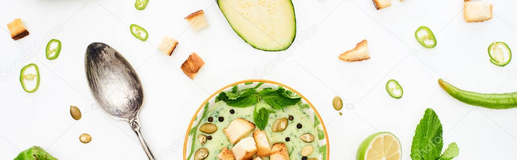 Panoramic shot of delicious creamy green vegetable soup with silver spoon isolated on white — Stock Image Panoramic Shot Delicious Creamy Green Vegetable Soup Silver Spoon Isolated Stock Image