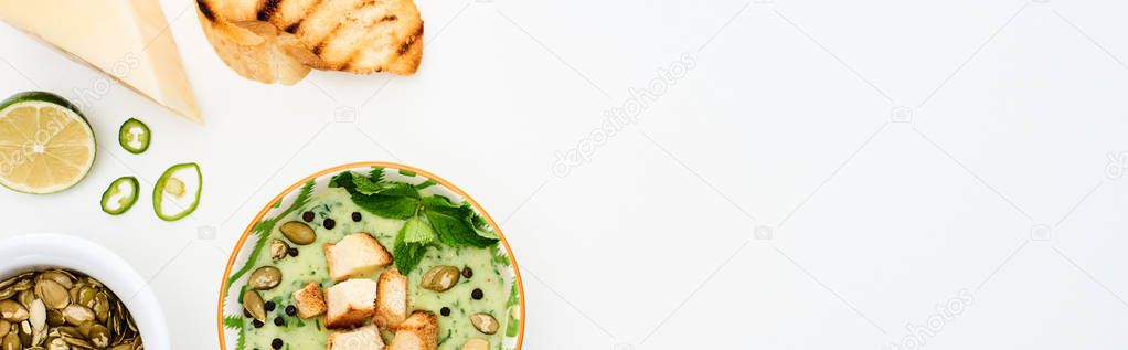 Top view of delicious creamy green vegetable soup with sprouts, grilled croutons and pumpkin seeds isolated on white, panoramic shot — Stock Image Top View Delicious Creamy Green Vegetable Soup Sprouts Grilled Croutons Stock Image