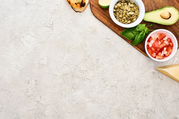 Top View Pumpkin Seeds Avocado Mint Tomatoes Wooden Chopping Board — Stock Photo, Image