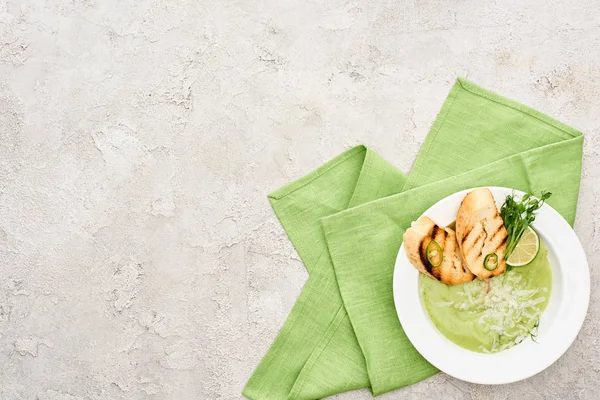 Top view of delicious creamy green vegetable soup with sprouts and croutons served with napkin — Stock Image Top View Delicious Creamy Green Vegetable Soup Sprouts Croutons Served Stock Photo