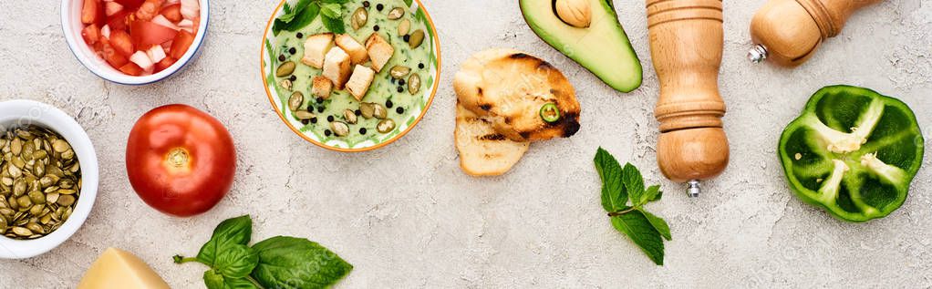 Panoramic shot of delicious creamy green vegetable soup near fresh vegetables on textured surface — Stock Image Panoramic Shot Delicious Creamy Green Vegetable Soup Fresh Vegetables Textured Stock Image
