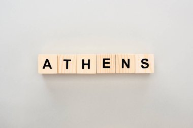 top view of wooden blocks with Athens lettering on grey background clipart