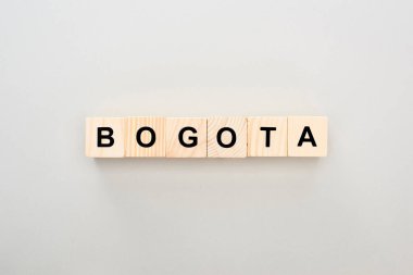 top view of wooden blocks with Bogota lettering on grey background clipart