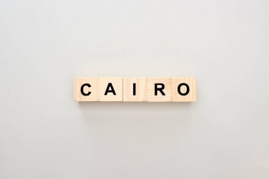 top view of wooden blocks with Cairo lettering on grey background clipart