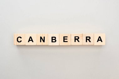 top view of wooden blocks with Canberra lettering on grey background clipart