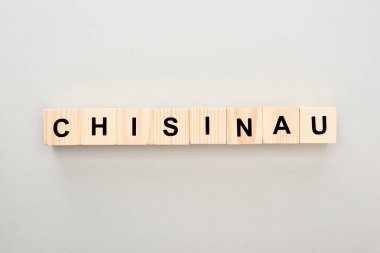 top view of wooden blocks with Chisinau lettering on grey background clipart