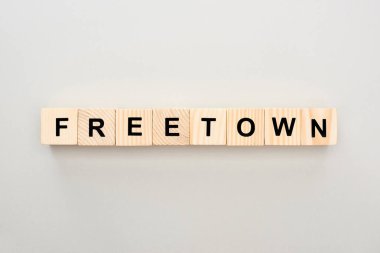top view of wooden blocks with Freetown lettering on grey background clipart