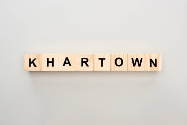 top view of wooden blocks with Khartown lettering on grey background clipart