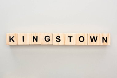top view of wooden blocks with Kingstown lettering on grey background clipart