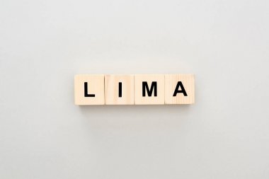 top view of wooden blocks with Lima lettering on grey background clipart