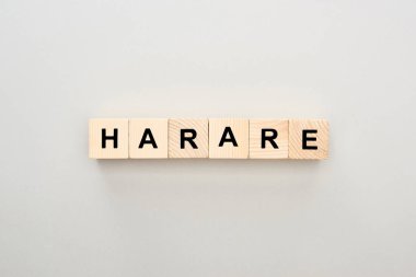 top view of wooden blocks with Harare lettering on grey background clipart