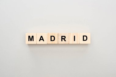 top view of wooden blocks with Madrid lettering on grey background clipart