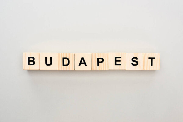 top view of wooden blocks with Budapest lettering on grey background