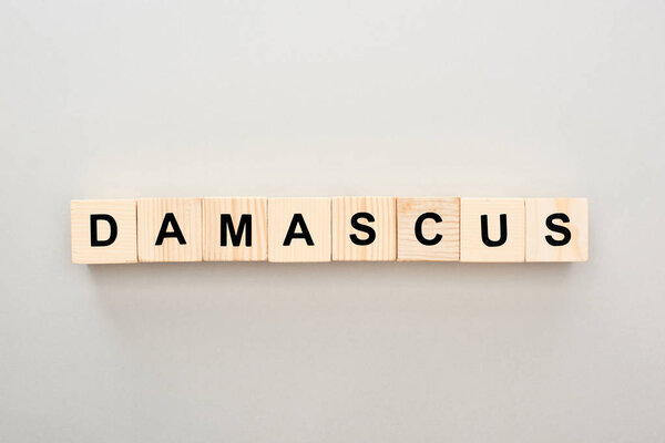 top view of wooden blocks with Damascus lettering on grey background