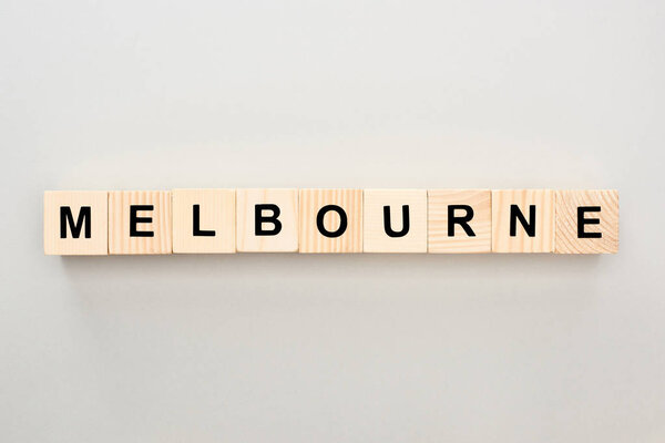 top view of wooden blocks with Melbourne lettering on grey background