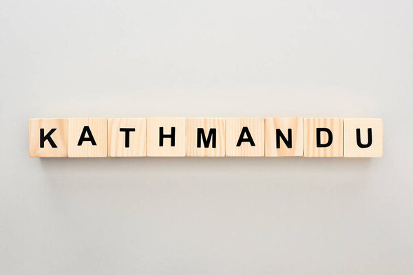 top view of wooden blocks with Kathmandu lettering on grey background