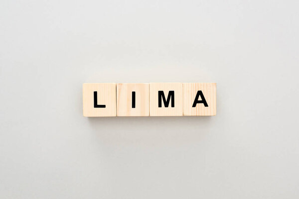 top view of wooden blocks with Lima lettering on grey background