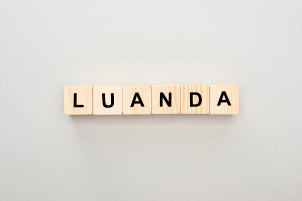 top view of wooden blocks with Luanda lettering on grey background
