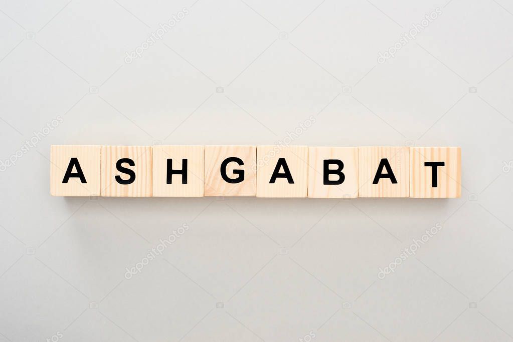 top view of wooden blocks with Ashgabat lettering on grey background