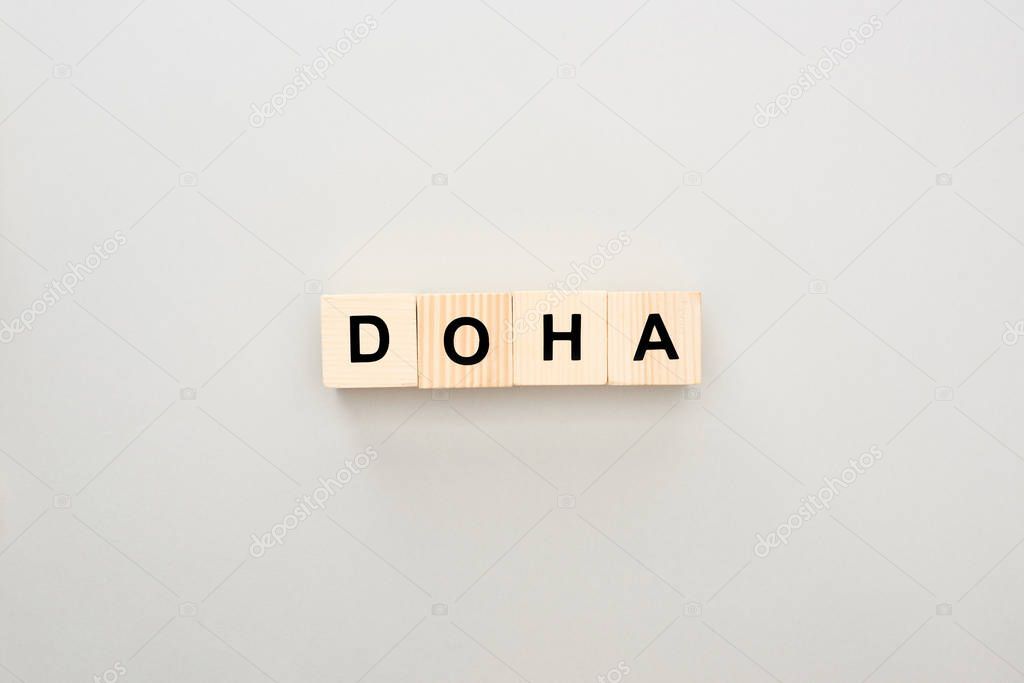 Top view of wooden blocks with Doha lettering on grey background