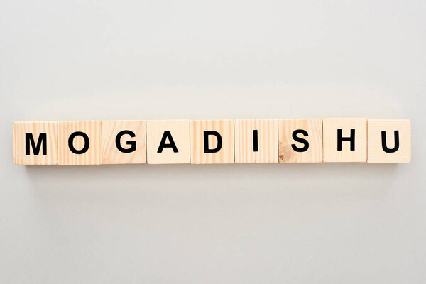 top view of wooden blocks with Mogadishu lettering on grey background