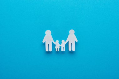 top view of paper cut family holding hands on blue background clipart
