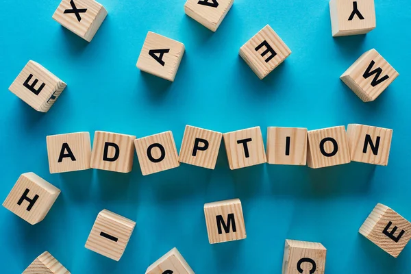 Top View Adoption Word Made Wooden Cubes Blue Background — Stock Photo, Image