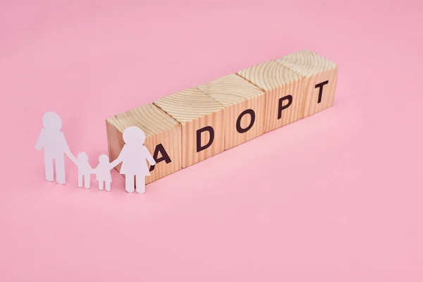 Wooden Cubes Adopt Lettering Paper Cut Family Pink Background — Stock Photo, Image