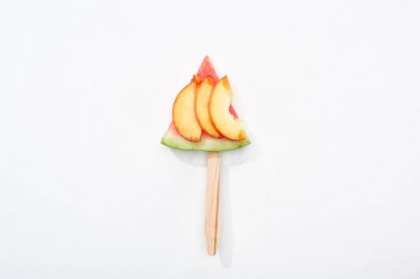 top view of delicious watermelon on stick with nectarine on white background clipart