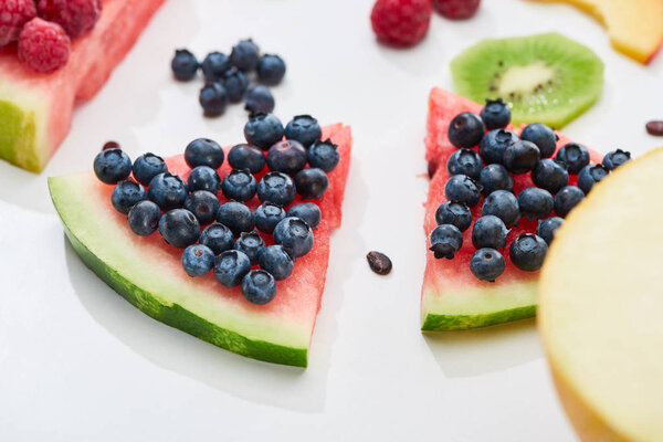 delicious dessert with watermelon and blueberries on white background