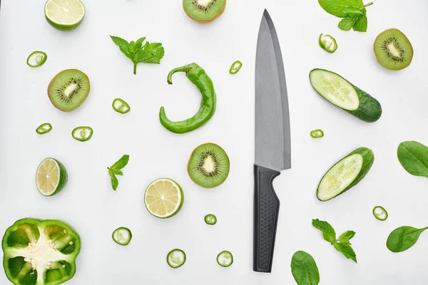 Top View Knife Fresh Cucumbers Kiwi Limes Peppers Greenery — Stock Photo, Image