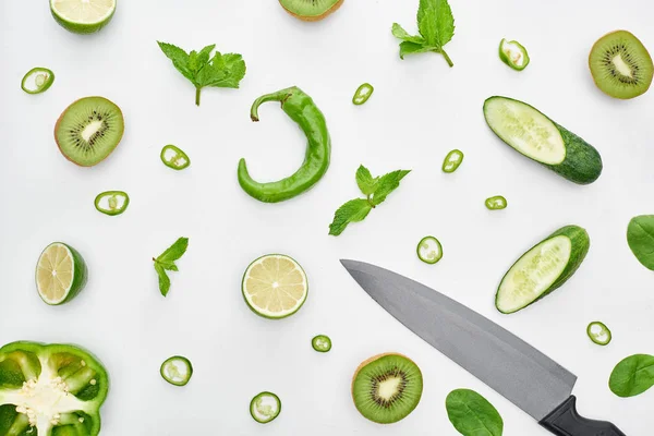 Top View Knife Fresh Cucumbers Kiwi Limes Peppers Greenery — Stock Photo, Image