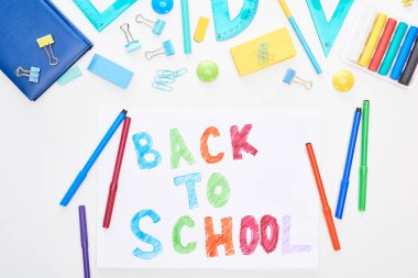Top view of paper with back to school lettering near colorful felt-tip pens and stationery isolated on white clipart