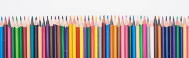 Panoramic shot of straight line of color pencils isolated on white  clipart