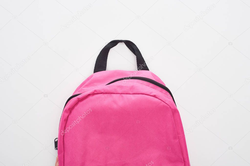 Closed bright pink school bag isolated on white