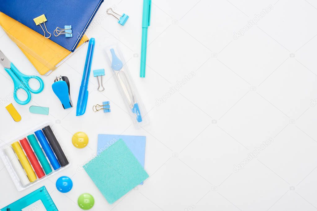 Blue and white school supplies isolated on white