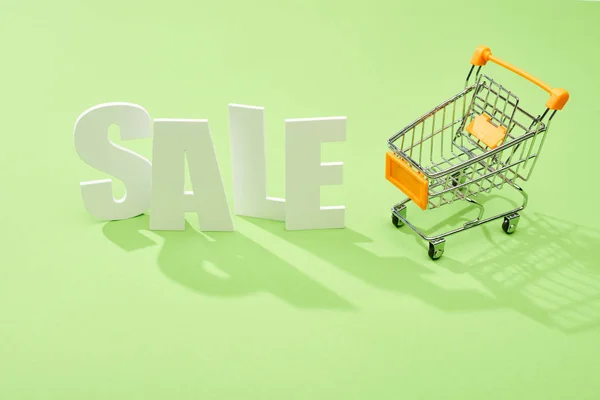 White Sale Lettering Decorative Shopping Cart Green Background — Stock Photo, Image