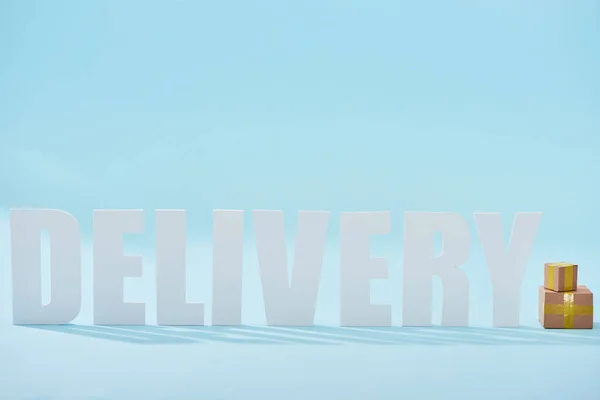 White Delivery Word Closed Cardboard Boxes Blue Background Copy Space — Stock Photo, Image