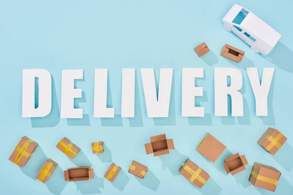 Top View Delivery Lettering Shadows Cardboard Boxes Van Blue Background — Stock Photo, Image