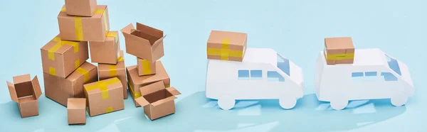 Panoramic Shot Pile Cardboard Boxes Mini Trucks Blue Background — Stock Photo, Image