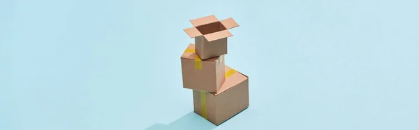 Panoramic Shot Cardboard Boxes One Top Each Other Blue Background — Stock Photo, Image