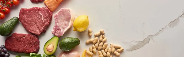 Panoramic Shot Raw Meat Steak Avocados Lemon Peanuts Marble Surface — Stock Photo, Image