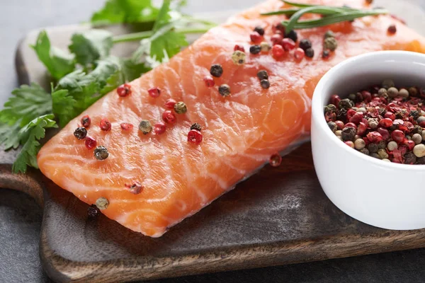 Uncooked Salmon Peppercorns Parsley Rosemary Wooden Cutting Board — Stock Photo, Image